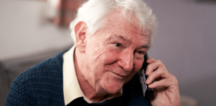 Man of pension age talking on the phone