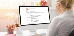 Image of a woman looking at a computer monitor screen while writing her CV: CV Builder