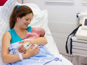 A mother holding her newborn baby in her arms