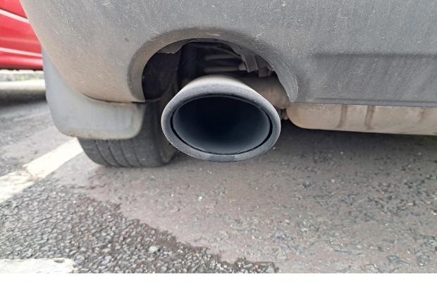 Image of a sooty exhaust tailpipe on a car